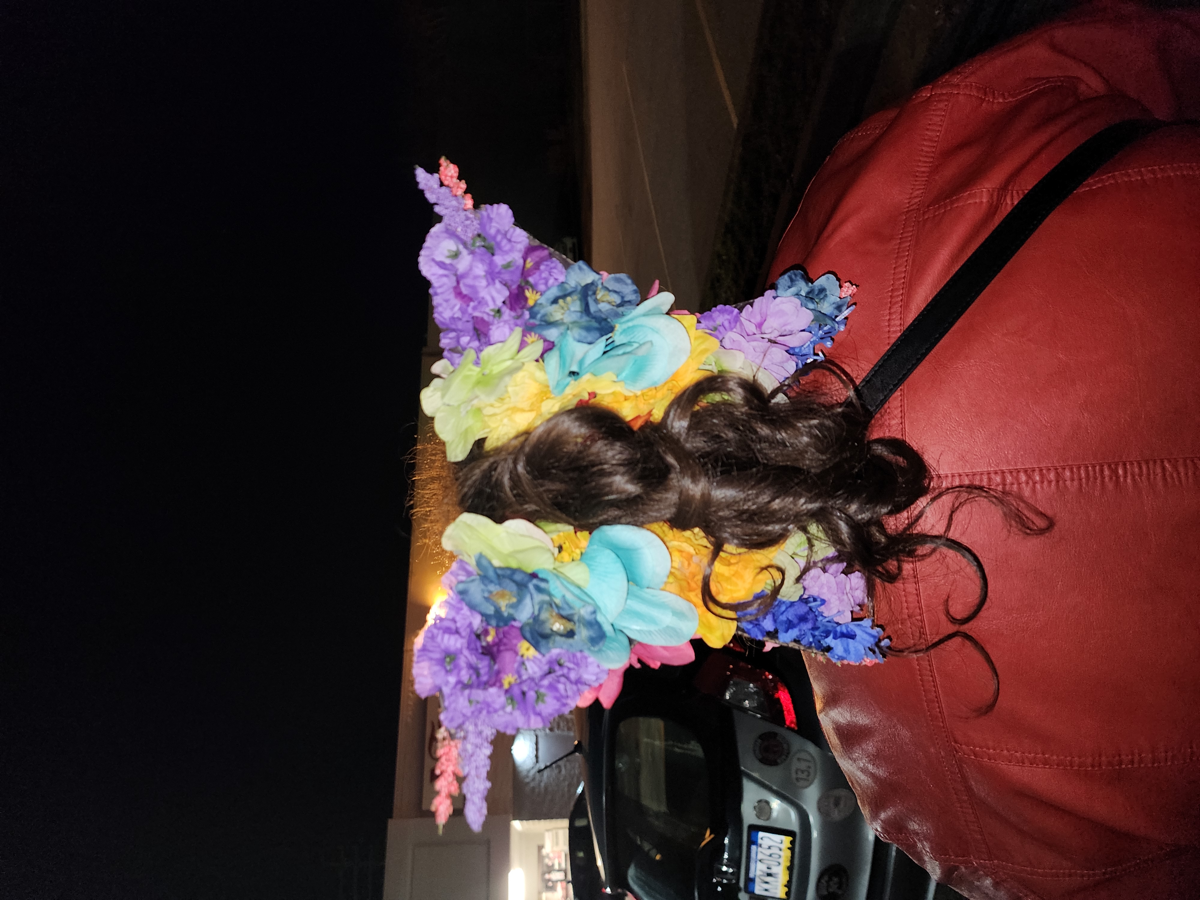 Spring 2024: Hair clip I made for a drag event. Used cardboard, wire and hot glue to attach flowers and a hair clip. Modeled by me after the event. Original design by me